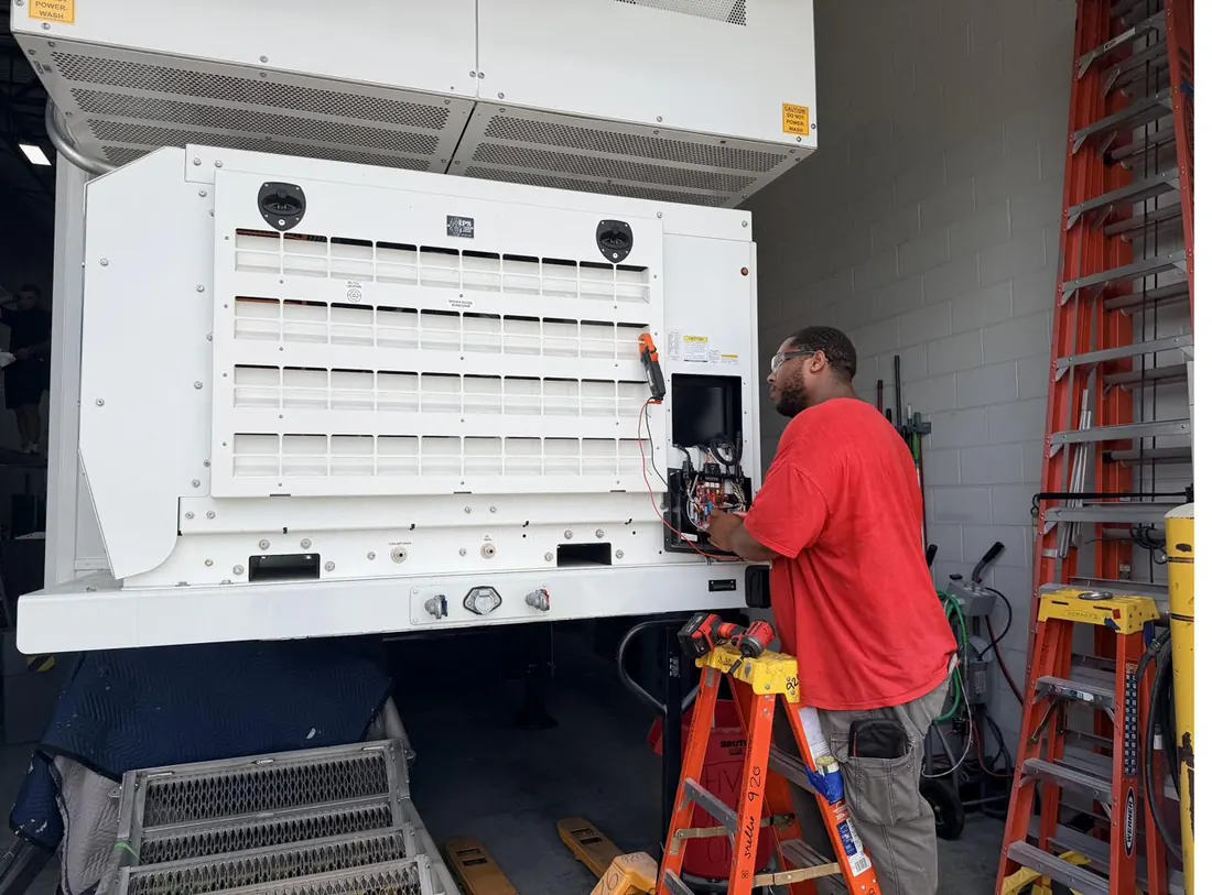 TreVince wiring the control compartment of a large HVAC condenser unit