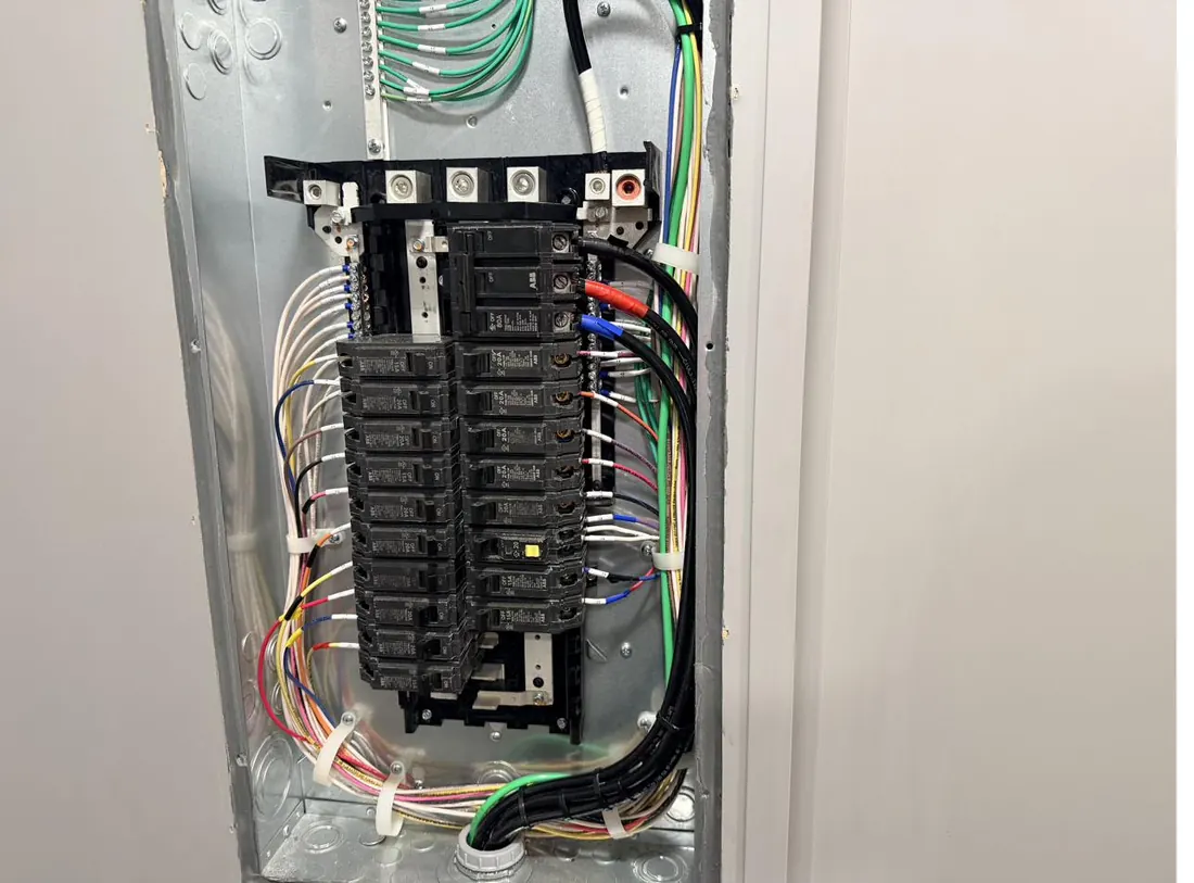Fully terminated breaker panel with dressed conductors in a mobile trailer